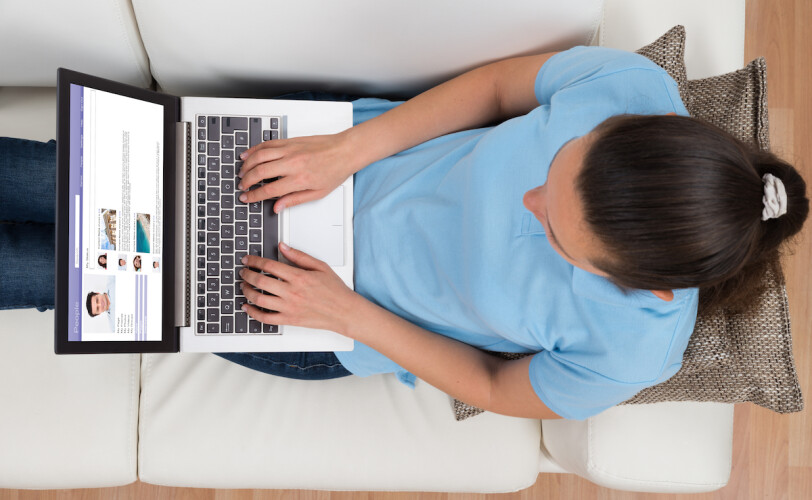 Woman browsing counsellor profiles on her laptop